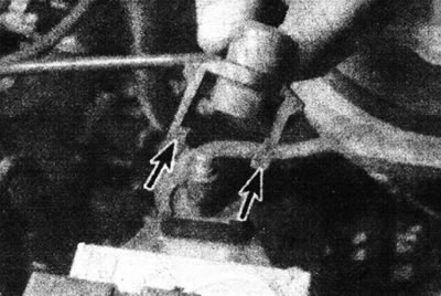 4.1. Disconnect the high voltage wire from the ignition coil. Note the locking tabs (marked with…