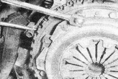 4.2а. Адкруціце мантажныя балты кажуха счаплення, заблакаваўшы махавік адвёрткай.