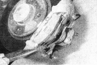 16.2b.... then remove the mounting plate from the caliper.