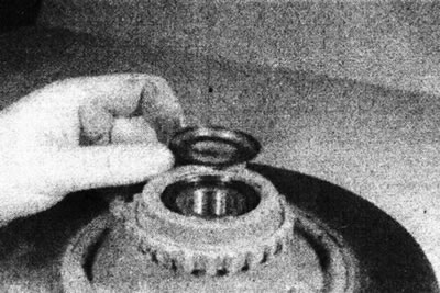 18.9a. Place the spacer shim on the brake disc...