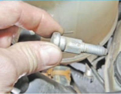 bend back the boot covering the lower universal joint of the steering shaft under the vehicle and…